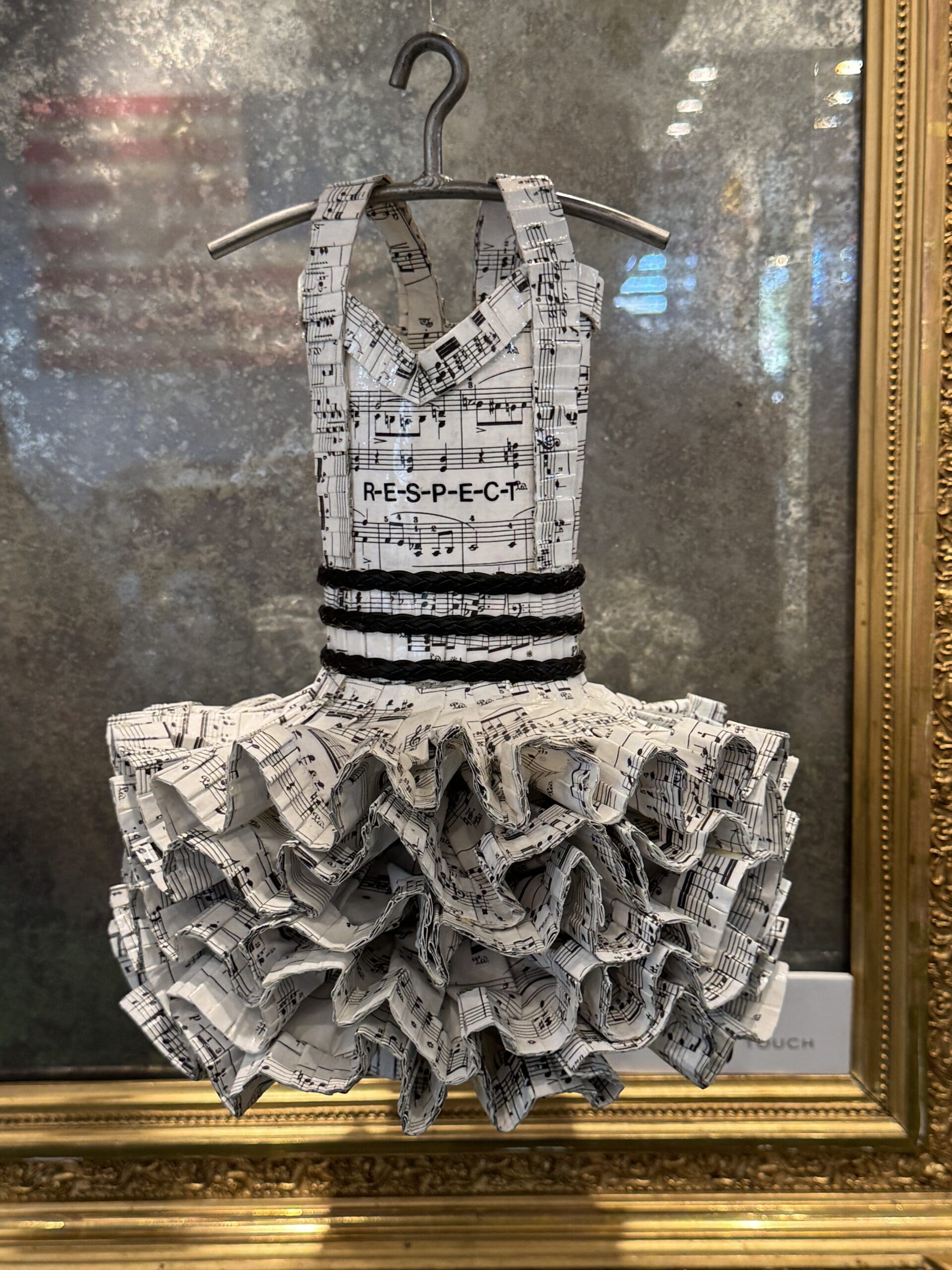 Dress made from sheet music with “RESPECT” displayed.