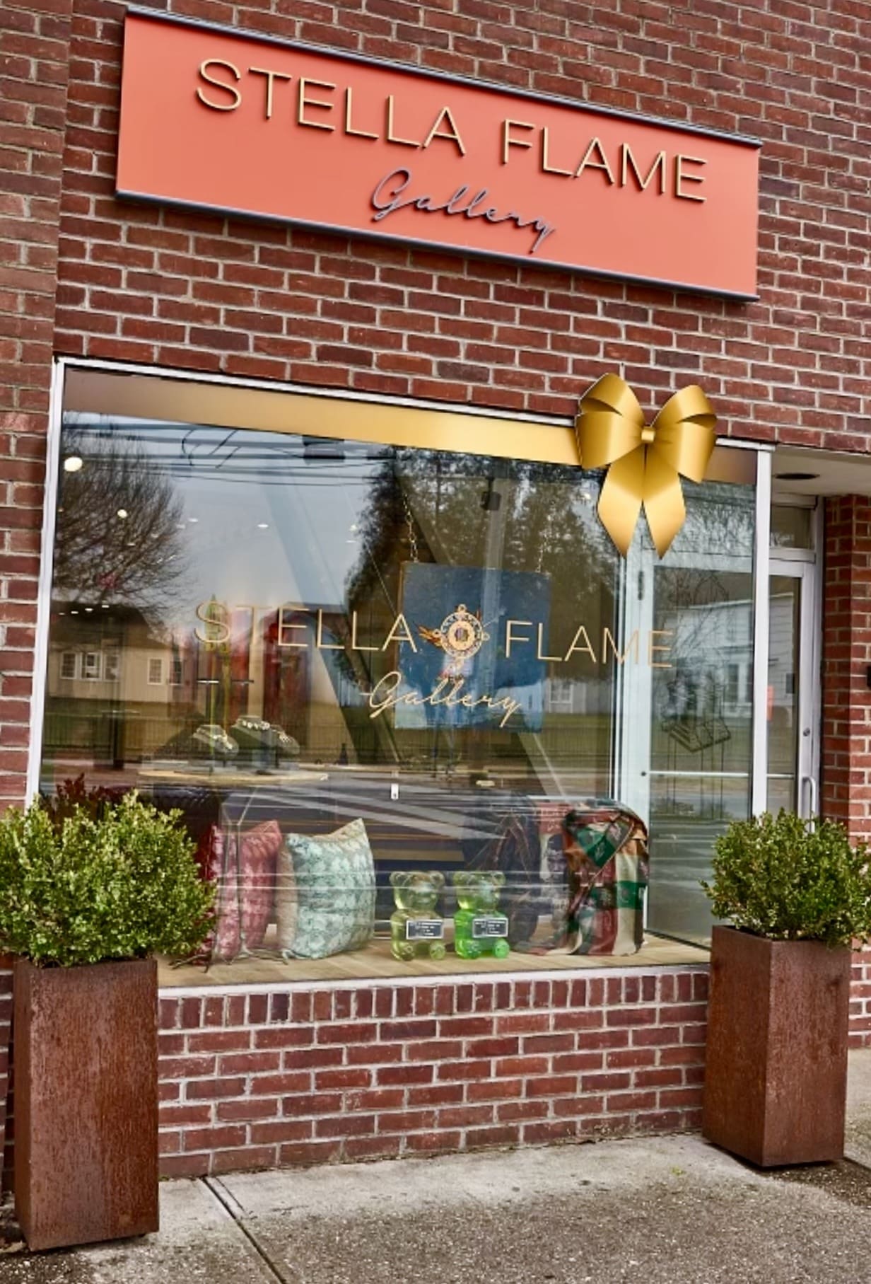 Stella Flame Gallery exterior with pillows, bears, greenery.