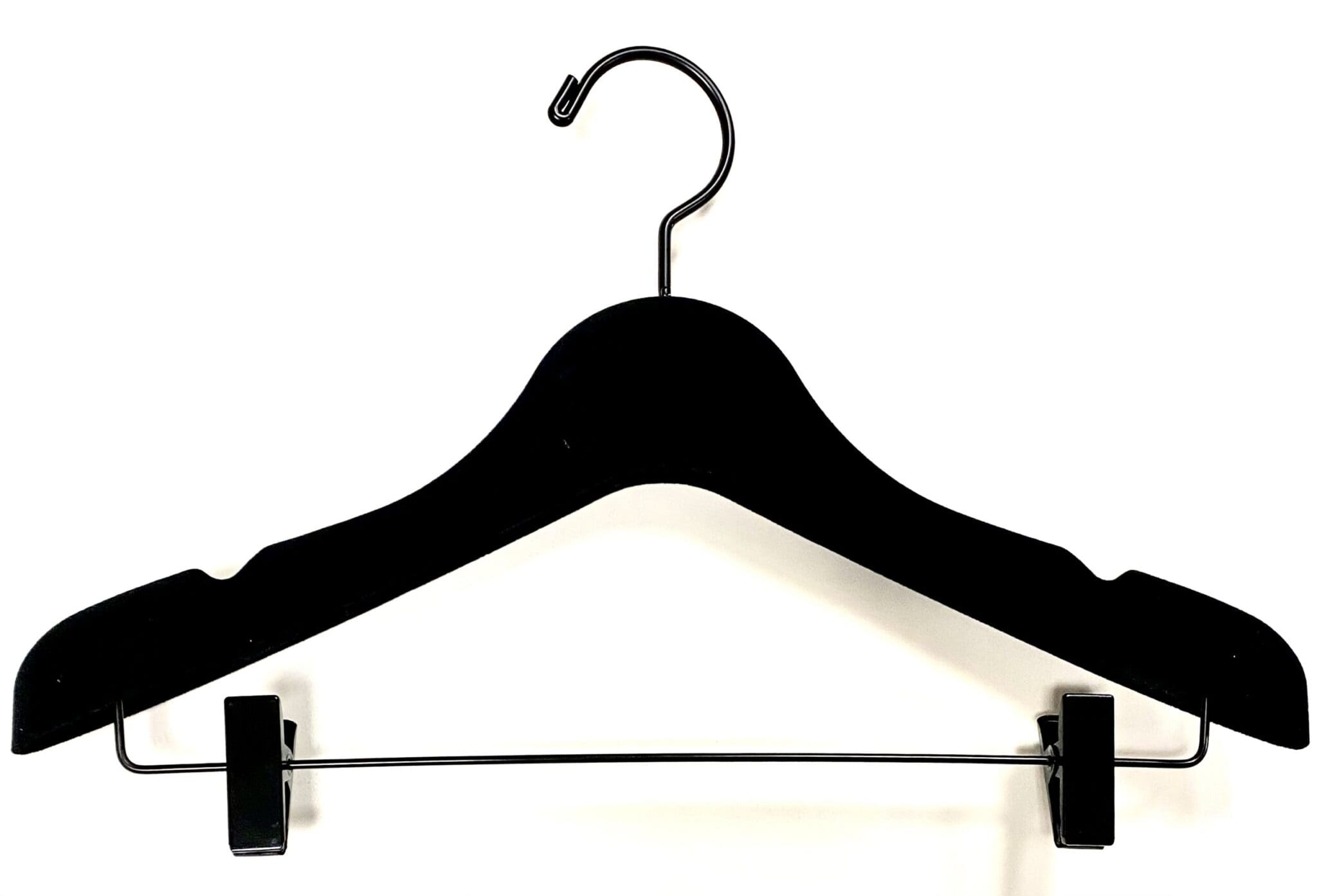 Black velvet hanger with clips, designed for hanging clothing securely. Ideal for showcasing garments in retail or organizing closets.