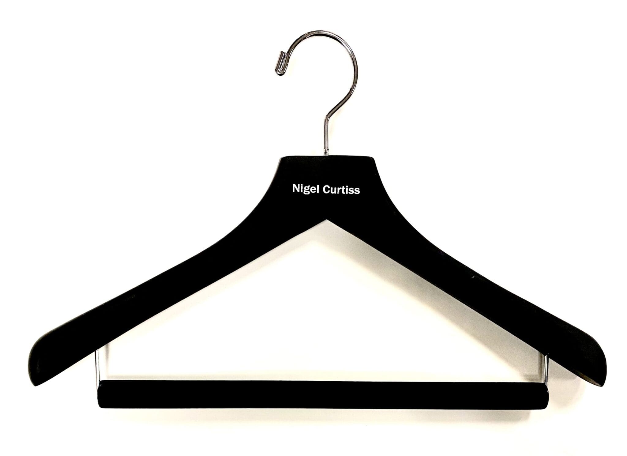 Black wooden hanger with a chrome hook, labeled "Nigel Curtiss," displayed against a plain white background. Suitable for fashion or retail context.