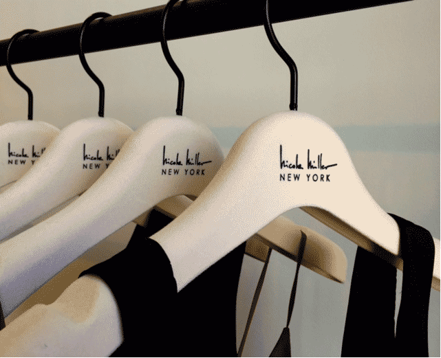 Hicah Killer New York hangers display stylish black garments.
