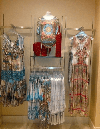 Colorful summer dresses with floral, geometric patterns displayed.