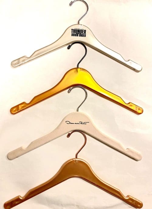 Four stacked hangers: white branded, three amber, one signed.