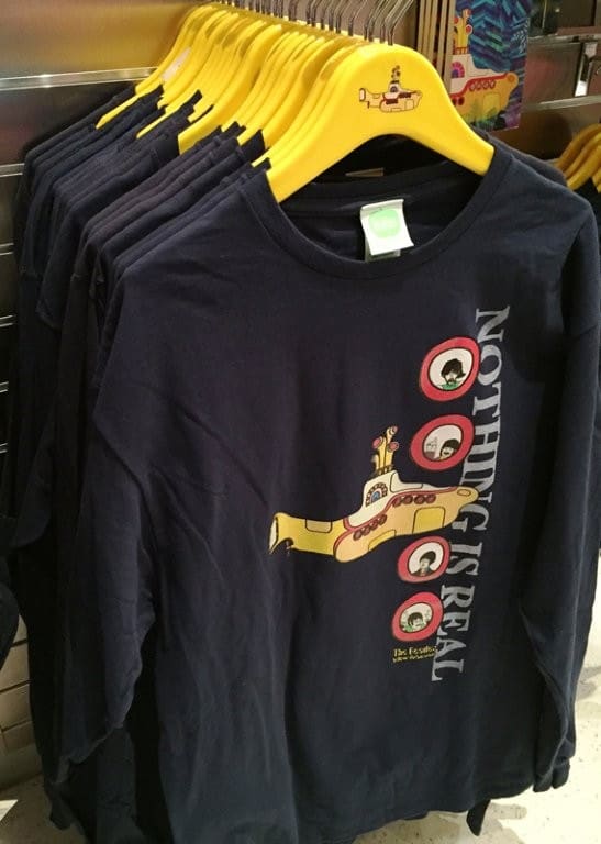 Navy long-sleeve t-shirts display yellow submarine, nostalgic text.