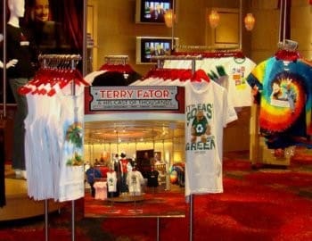 Terry Fator booth displays colorful shirts and tank tops.