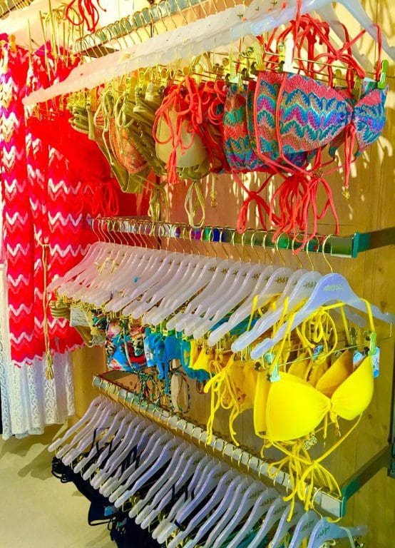 Colorful swimwear displays bikinis and cover-ups, showcasing trends.