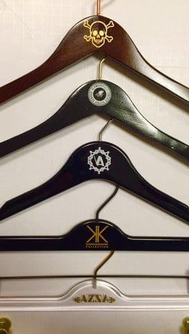 Five colorful hangers display logos, skulls, and patterns.