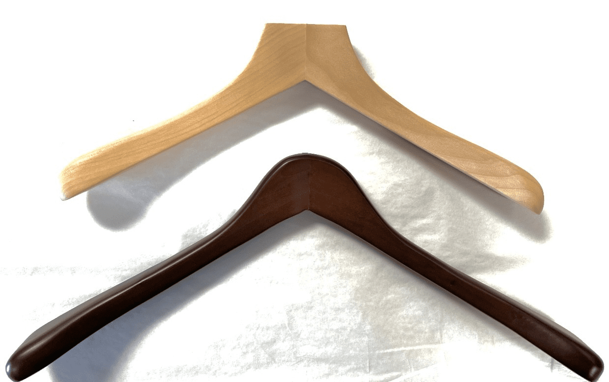 Two wooden hangers—one light, one dark—against white backdrop highlighting finish contrast.
